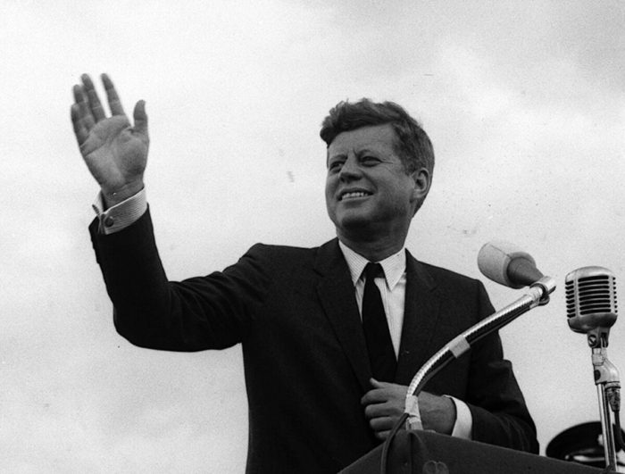 President Kennedy smiling and waving